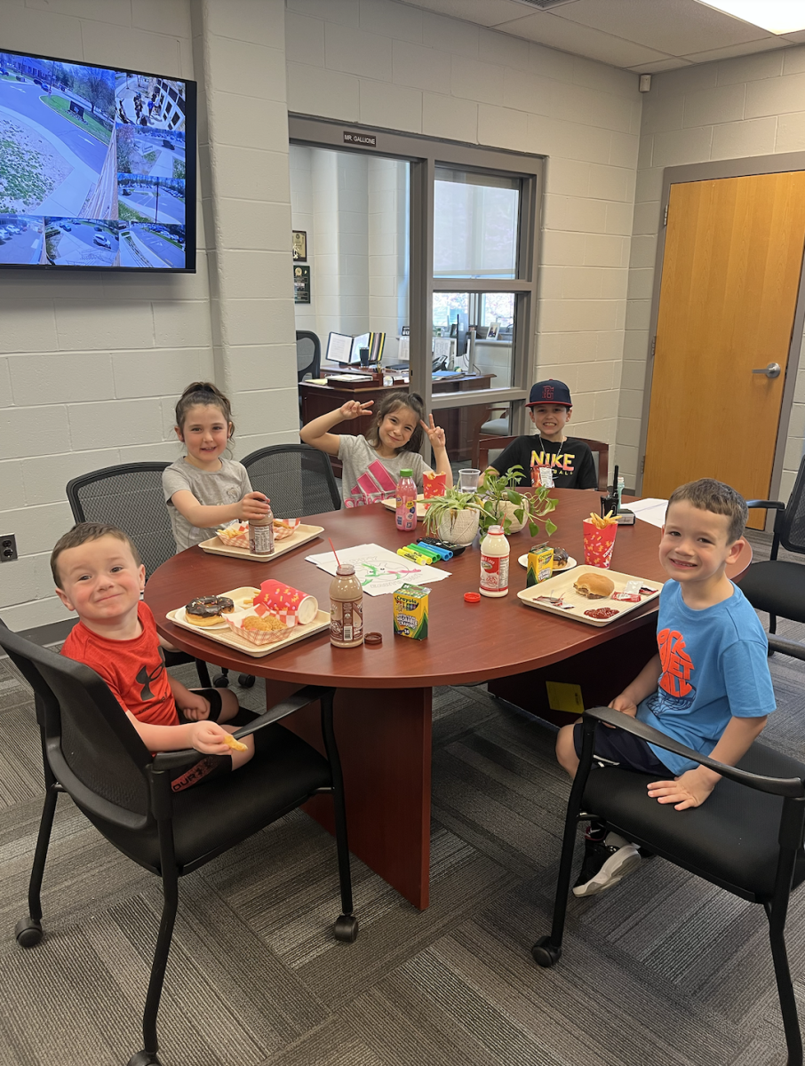 PV faculty's kids Logan Taylor, Harper Gallione, Chloe Lombardo, Jack Gallione, and Brady Taylor (left to right) eat lunch in the main office.